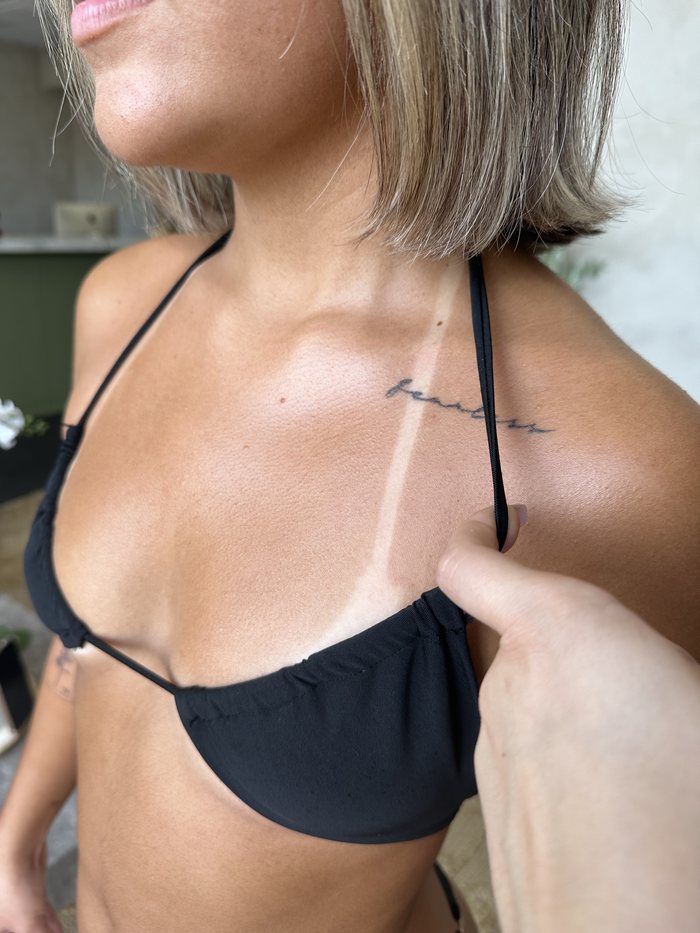Spray tan result across the shoulder and collarbone
